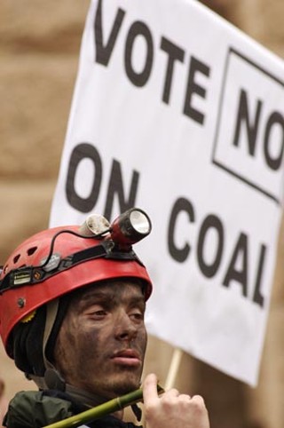 An activist rallying against TXU at the Capitol last month