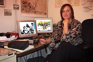 <i>Austin Past and Present</i> creator Karen Kocher displays two of the project's prized images: the Austin History Center's 1964 photo of Joan Baez at a City Council civil rights read-in and Charles Shaw's painting of the 1709 Pedro de Aguirre expedition.