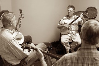 Bob Carlin (r) gives a banjo workshop at Violins, Etc., 8620 Burnet Rd.