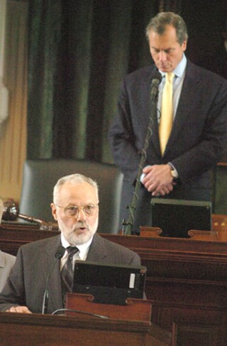 Imam Yusuf Kavakci of the Dallas Central Mosque (with Lt. Gov. David Dewhurst in background) became the first Muslim cleric to deliver an Islamic prayer before the Texas Senate last week. The third annual Texas Muslims Legislative Day on April 4 almost went off without a hitch, with only freshman Sen. Dan Patrick, R-Houston, casting a shadow on the Muslim community’s rare moment of state recognition. Patrick, a Houston radio jock who subscribes to the views of an extremist Christian sect, boycotted the prayer, not only demonstrating a lack of respect for the imam and visiting Muslims on hand to witness the historic occasion, but also breaking with Senate decorum by snubbing an event sponsored by a ranking member – in this case Education Chair Florence Shapiro. Shapiro, who is Jewish, praised the imam for his leadership roles in a host of interfaith-related activities in Dallas and across the state. And as Patrick now knows, it’s not nice to piss off Mother Shapiro. After the prayer, Shapiro went out of her way to call attention to Patrick’s vacant seat when she expressed gratitude to “28 of my colleagues on the Senate floor.” (See “Quote of the Week”) Later, before the Senate adjourned for the day, Patrick delivered a personal privilege speech in which he described the morning prayer as “an extraordinary moment,” while pointing out that Jews and Christians are denied the same right to public prayer in many other places in the world. “I’m proud of my faith as a Christian,” he said. <i>Amy Smith</i>