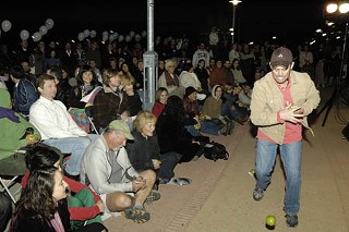 Week 1: Actor Martin Burke hands out 365 apples on the Pfluger Bridge.