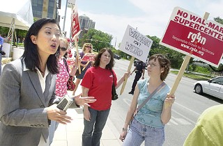 Jennifer Kim (left) was the only City Council member who broke from
the dais last Thursday to show support for Arms Around Austin – a
Responsible Growth for Northcross protest at City Hall. RG4N is calling
upon council to use its authority under the city’s Land Development Code
to deny, on the basis of a traffic-impact analysis, a second site permit
filed by Northcross Mall redeveloper Lincoln Properties. During citizen
communication at the May 17 council session, RG4N attorney Brad Rockwell
presented a compelling Memorandum of Law arguing that council does, in
fact, have legal authority to deny the site plan. To date, the city
attorney has vigorously advised council members that they have no
authority to act in the matter.
  <br>   Rockwell’s memorandum (<a href=http://www.austinchronicle.com/issues/dispatch/2007-05-25/RG4NCouncilAuthorityMemo5-17-07.pdf target=blank><b>click here to download PDF</b></a>) states,
“Certain members of City staff have aggressively pursued an
interpretation of City Code that favors Lincoln Property and Wal-Mart
and appear to have gone to extreme measures to usurp the role of City
Council in the land development process.” It cites specific sections of
the code that give council authority to act on the basis of a
traffic-impact analysis. Rockwell makes the argument that by city code,
“the Council either ‘may’ or ‘must’ deny a site plan. Second, these
sections establish two different duties on the council, one
discretionary and one mandatory. The Lincoln Property TIAs have and will
demonstrate facts that provide the council with both the discretionary
opportunity to deny the site plan and the mandatory duty to deny it.”
Several council members contacted said they would further explore
Rockwell’s argument.
 <br>    Last week RG4N also protested a “threat letter” from Wal-Mart
Realty to the city; a Saturday event at the Norwood Wal-Mart drew more
than 100 protesters. In a letter to Assistant City Manager Laura
Huffman, Wal-Mart threatened to “re-evaluate” all of the project
revisions to which it already has agreed, if “3rd party litigation is
filed.” RG4N and the Allandale Neighborhood Association still are
planning to sue the parties and the city.                            – <i>Katherine Gregor</i>