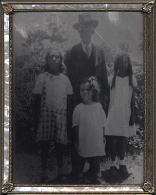 Educator L.C. Anderson, for whom Anderson High School is named, with his Crafton granddaughters. Ernie Mae stands in the middle.