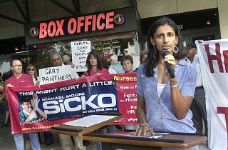 Dr. Amina Haji was one of several health-care professionals who gathered outside the Regal Arbor Cinema last Friday for the premiere of the Michael Moore documentary <i>Sicko</i> and to voice support for House Resolution 676, congressional legislation that would establish a single-payer system of universal health care. The Scrubs for <i>Sicko</i> event was organized by the California Nurses Association and the National Nurses Organizing Committee.
