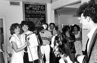 Lyle Lovett (far right) serenades Walter and Heidi Hyatt on their wedding day.