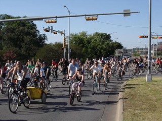 Critical Mass adds bareheaded bikers to the Friday rush-hour melee.
