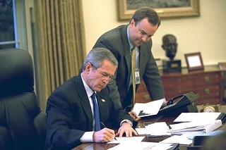 Deputy White House press secretary Scott McClellan and President George W. Bush work on a press statement in friendlier times.