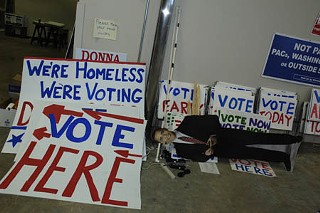 It's a sign of the times at Democratic headquarters as volunteers, aided by a cutout of Barack Obama, prepare to blanket the town with political signs in the run-up to Election Day.