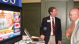 Jones checking out election returns with voters -- and McCain's big head on the TV