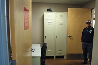 The women's locker room at Station 15: A desk and chair were moved into the room the day Nona Allen, standing in doorway, was transferred to Station 26.