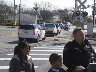 Austin police warn motorists not to stop on the MetroRail tracks, while actual drivers helpfully provide visual aids.