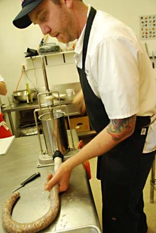Jesse Griffiths stuffs kielbasa.