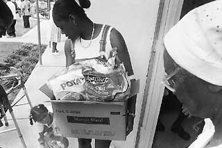 Each week, Capital Area Food Bank volunteers and staff divide perishable food for each recipient's box.