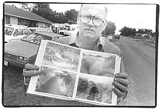 Kenneth Snyder holds a photo album documenting 
what life is like for residents of Northridge Acres.
