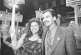 Raul Alvarez and a supporter celebrate his close 
victory over Rafael Quintanilla for the Place 2 City 
Council spot Saturday night.