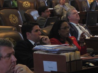 Dripping Springs Rep. Patrick Rose (l) anxiously watches the board with fellow Democrat Dawnna Dukes of Austin during his bill's verification vote.