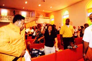 Pastor Nathanial Thomas gets the Sunday service fired up.