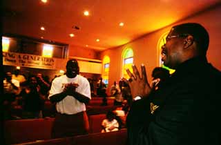 Danny Thomas (right) ministers at the Eph'phatha Full Gospel Baptist Church