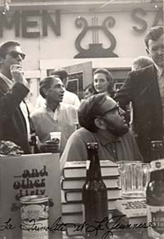 Holding a booksigning at Scholz Garten (in this case, for Larry L. King's <i>… and other dirty stories</i> in 1968) is the epitome of Mad Dog style: a little beer with your books. The man smoking behind King (seated) is artist Fletcher Boone, and behind him, Bill Brammer.
<p>(Larry L. King Archives, Southwestern Writers Collection, Southwest Texas State University)