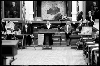 Rep. Senfronia Thompson, D-Houston, the House sponsor of the James Byrd Jr. hate crimes bill, addresses state representatives shortly before they approved the measure. An oversized photograph of Rep. Wayne Christian, who opposed the bill, rests on an easel to Thompson's right. Christian represents the town of Jasper, where Byrd, an African-American, was dragged to death behind a truck driven by three white men.
