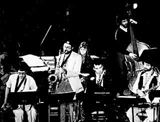 Alex Coke and Tina Marsh (center, standing) at the Creative Opportunity Orchestra's inaugural show at the Paramount Theatre, 1980
