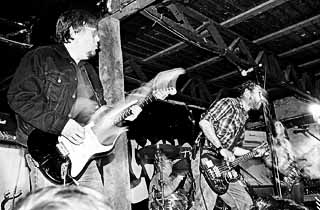Ron Asheton and Mike Watt on the outside stage at Emo's, SXSW 2001