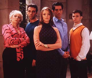 Natalia Carlisle (Shawn Batten, center) cracks the whip at video-game empire Spyder Games. She's flanked (from left) by the assistant she tried to fire (Mink Stole), her suspicious brother Dmitri (Joseph R. Cacia), her closeted brother Ivan (Byron Field), and her secret admirer Todd (Travis Wester).
