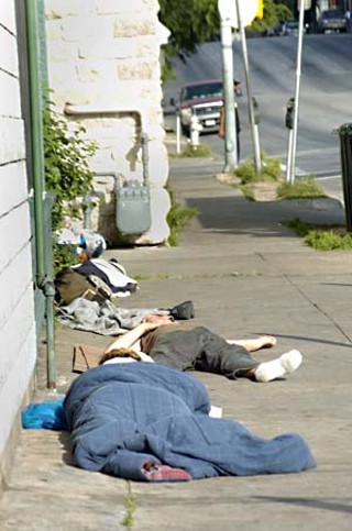 Homeless people sleeping on an East Seventh Street sidewalk