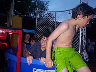 Spring Party 2001: <i>Chron</i>spawn Eli Black (right) and friend emerge from the dunking booth that has become a fixture at recent <i>Chronicle</i> parties. Advertising Manager Carol Flagg is a more frequent victim.