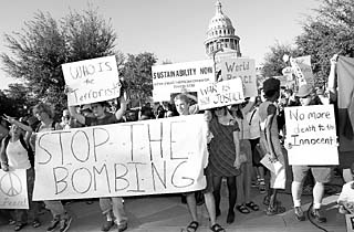 When war broke out on Sunday, Austin's peace activists quickly wheeled into action. By 5:30pm that evening, an anti-war rally had been organized at the state Capitol. Protesters were not allowed to use the typical meeting place of the Capitol steps because the Department of Public Safety had restricted access to the grounds, so this gathering was limited to the sidewalk on 11th Street.