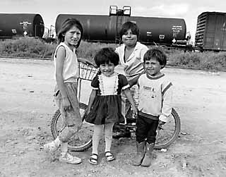 Children in Matamoros, Mexico, play in front of a railroad tanker carrying chlorine.

