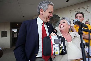 Texas AFL-CIO President Becky Moeller provides U.S. Rep. Lloyd Doggett, D-Austin, a “survival kit” to help him on his return to Congress to fight for health care reform. Also saluting Doggett at the Labor Day fish fry were the Austin Central Labor Council and the Texas and national Alliance for Retired Americans. Doggett said he would fight for a “strong public option” in the reform legislation and against attacks by “know-nothing, fear-mongering wing nuts – about the only people left in the Republican Party.”