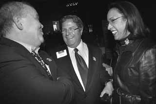 Former Dist. 51 Rep. Glen Maxey (l) and incumbent Dist. 50 Rep. Dawnna Dukes schmooze with gubernatorial candidate Tony Sanchez at the Travis County Democratic Party's Filing Day Party at the Austin Music Hall on Jan. 2. Sanchez wouldn't be smiling hours later, upon learning that former Texas Attorney General Dan Morales also had filed for governor. Morales and Sanchez traded jabs on Monday while seeking the AFL-CIO endorsement.