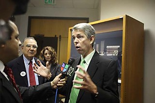 WallBuilder David Barton spins the media outside the SBOE boardroom.