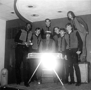 Meyers, with tambourine on his head, and Doug Sahm, standing far right on amp, mugging at Sam Kinsey’s Teen Canteen with the Spidels, another popular San Antonio band of the 1960s
