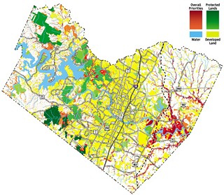 The Travis County Greenprint shows blended conservation priorities. 
Areas in dark red have the highest conser­vation priority, reflecting multiple goals.
Areas in orange are next highest. 
Land shown in green is already protected, either as dedicated parkland (light green) or water quality protection lands (dark green).