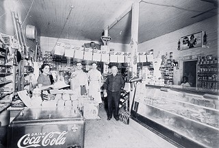 Mandola’s Grocery, 1936, Houston:
Damian’s grandfather Vincenzo “Vincent” Mandola is at right. Check out the meat case. This is very typical for Italian groceries of that time. It’s clear from dozens of pictures of Houston groceries from this same time period that it’s the meat case that sets the Italian grocers apart.