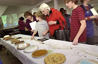 Guests bidding on pies at last year’s silent auction.