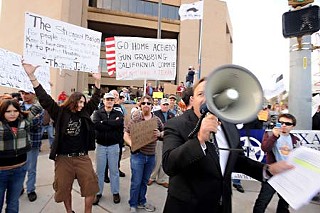 Hundreds of gun-rights activists rallied Monday at the Austin Police Department in response to recent law enforcement actions that led to the shutdown of a gun show scheduled Jan. 16-17. Local gadfly and conspiracy theorist Alex Jones is shown with bullhorn in foreground.