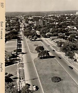 This undated photo, facing south, shows East Avenue before the construction of I-35. The four-lane boulevard was lined with houses on either side (you can also see Brackenridge hospital in the distance on the right) before it was replaced with the highway.