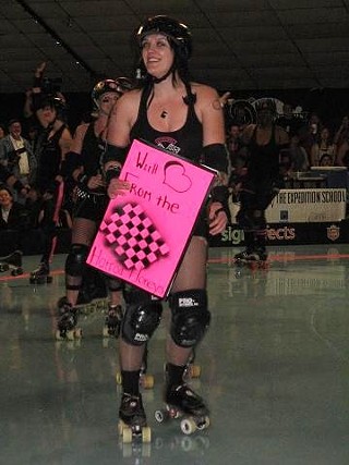 Rita Menweep, captain of the Honky Tonk Heartbreakers, signs autographs at Playland Skate Center, March 28, 2010