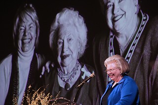 Sarah Weddington was among the speakers who celebrated the life of Liz Carpenter at a March 26 memorial at the LBJ Library. Behind her onscreen is a photo of Carpenter flanked by longtime friends Molly Ivins (l) and Weddington.