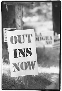 Out INS Now sign