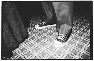 Guy in suit and tennis shoes